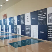 Long large wall full of large printed graphics