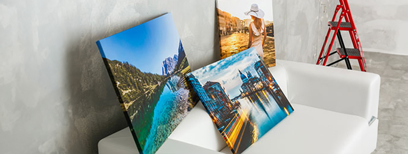 Multiple canvas wrapped art pieces displayed in a studio.