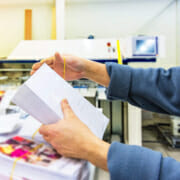 Person assembling a variable data printing project.