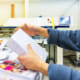 Person assembling a variable data printing project.