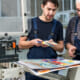 2 men at at print shop looking over color samples