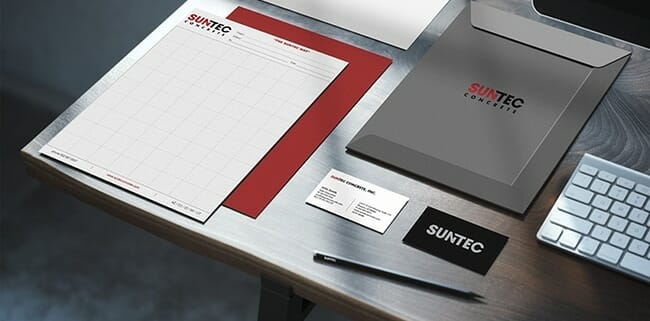 Desk showing examples of Suntec printed logos on letterhead, business cards, envelopes, etd.