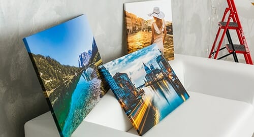 3 examples of full color canvas prints depicting landscape and people