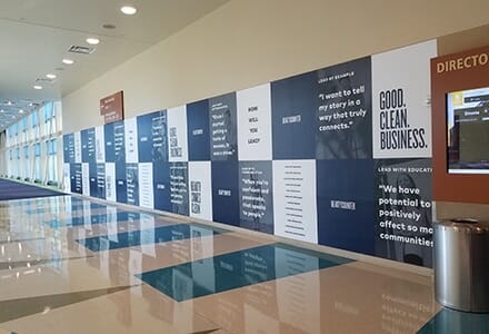 Printed wall graphics in a large hallway.