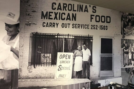 Large B&W printed wall graphic depicting mid century storefront for Carolina's Mexican Food