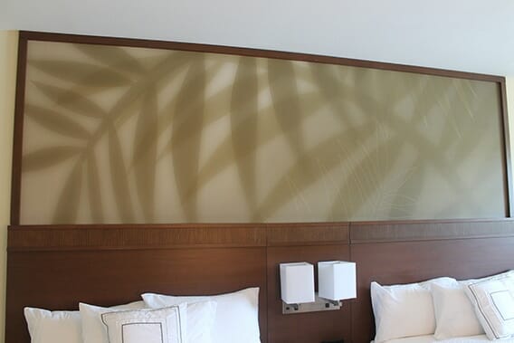 Large printed wall graphic above 2 queen beds in a hotel room