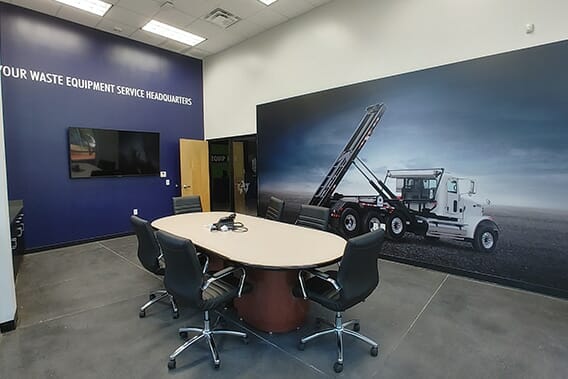 Boardroom with full wall graphics showing a waste management truck