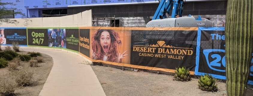 Construction Site Fence Banner - PRI Graphics & Signs excited woman printed on construction fence banner for desert diamond casino