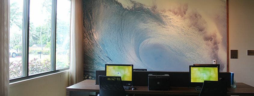 printed wallpaper of an ocean wave inside a business center for a hotel