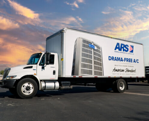 A large white delivery truck displaying vehicle wrap graphics.