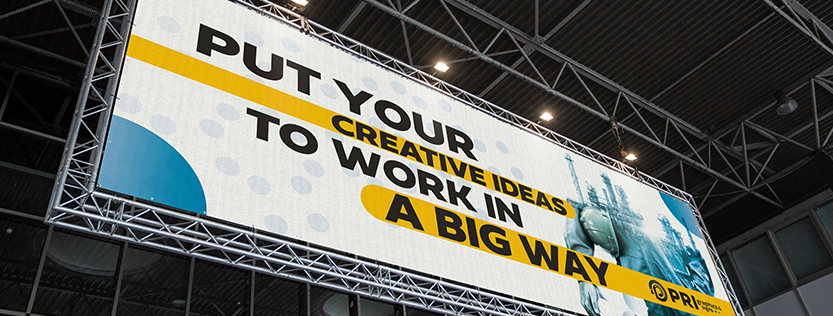 Large oversized event trade show banner hanging from the rafters.