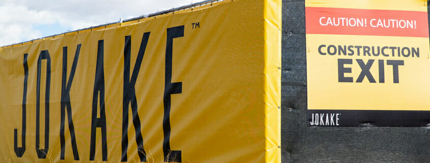 Vinyl fence banner wrap and construction sign for Jokake Construction.