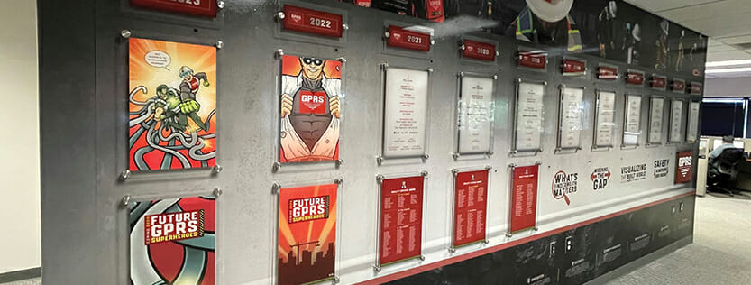Large wall with a display of branding graphics.