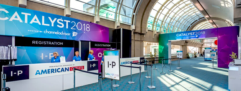 Large printed event graphics on display at a convention.