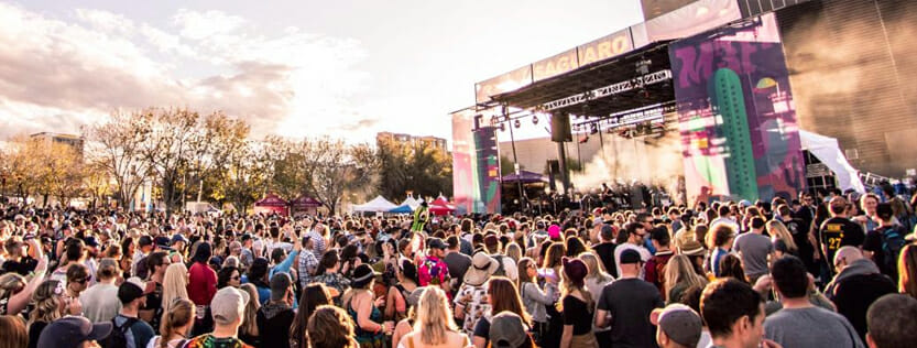 Large crowd in front of a stage at an outdoor event.