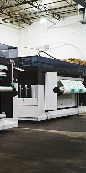 Large printing machine printing a color image.