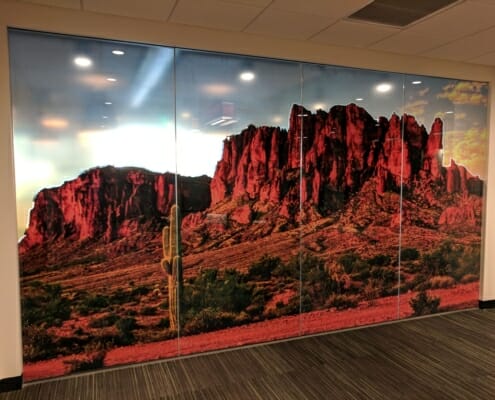 A 4-panel window graphic displaying a desert with red rock mountains.