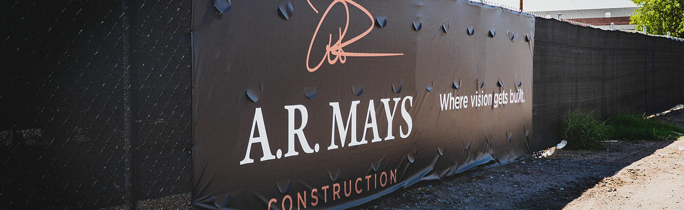 Construction fence banner with wind slits for A.R. Mays