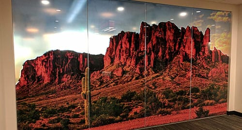 Perforated window graphics for privacy on a conference room.