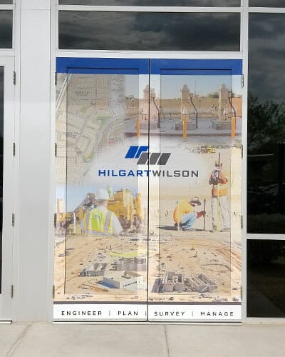 Perforated window vinyl for entrance doors of a construction company.