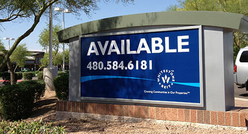 Backlit monument sign panel for property availability.