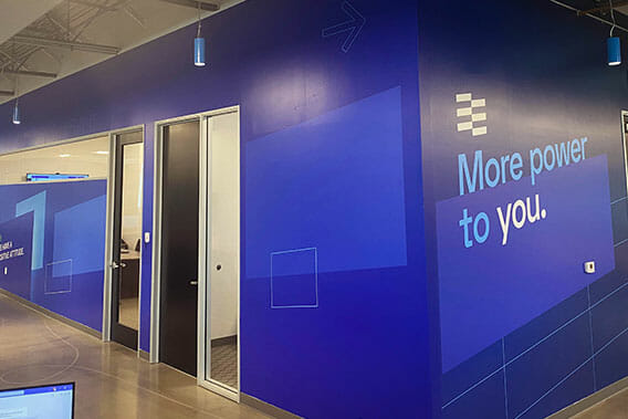 Interior graphics wall wrap featuring branding of solar company.