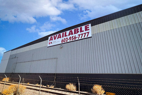 Building banner hung to a warehouse for a commercial real estate company.