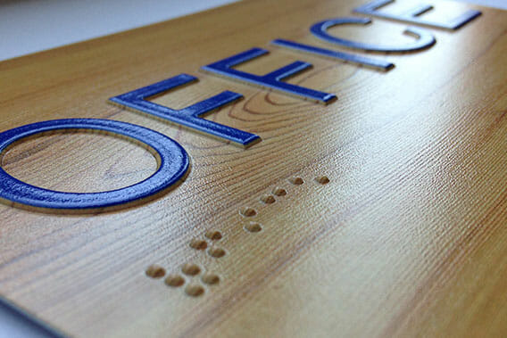 Office placard sign with braille texture printing.