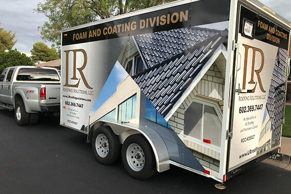 Printed vehicle wraps installed on a double axel trailer for LR Roofing Solutions.
