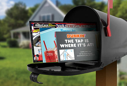 Postcards displayed in a black mail box with the red flag sticking up.