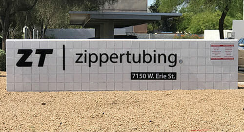 Pin mounted letters on a white brick monument.