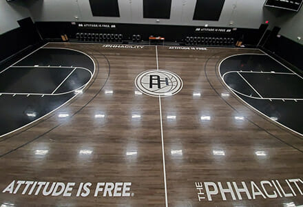 Overhead view of a basketball court with vinyl floor graphics for Attitude Is Free