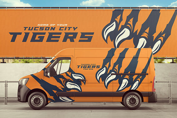 Matching Tucson Tigers logo on a van vehicle wrap plus on a background billboard.